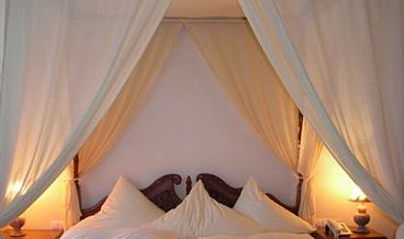 afbeelding van Tweepersoonskamer met hemelbed